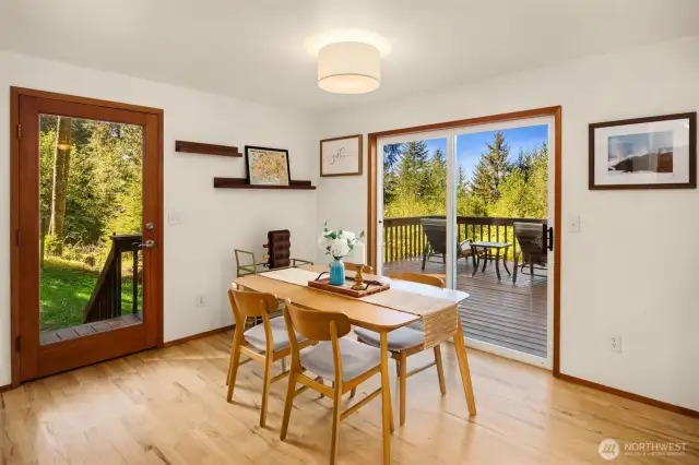 Sliding door to back deck and side door leading out to backyard.