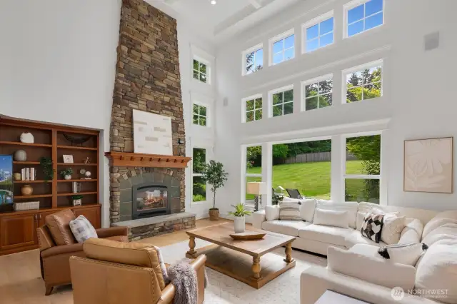 Wow family room with vaulted boxed ceilings, floor to ceiling stone fireplace and windows that keep it bright and cheery all year round.