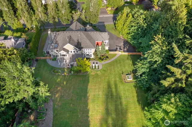 Expansive view of back of home and backyard. Don't miss the garden space with raised beds and fruit trees. 19 zone sprinkler system.