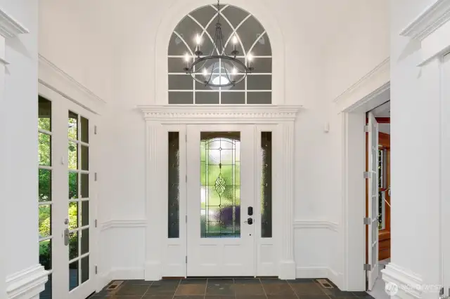 Elegant foyer with Extensive millwork, French doors and attention to detail make this home shine.