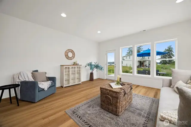 The living room looks out to the saltwater views and opens to the patio.