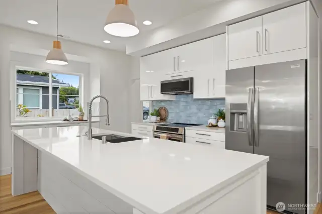 Another view of this beautiful, sleek kitchen with the gorgeous blue tile backsplash that mimics the water.