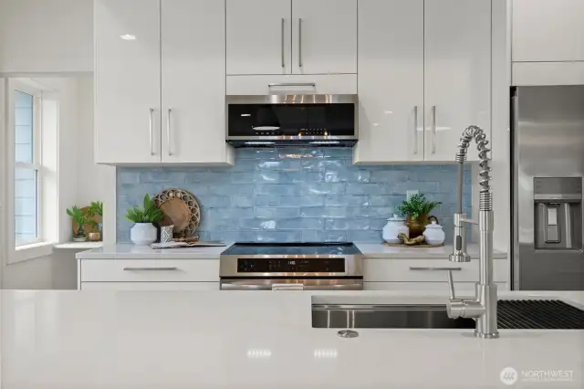 The backsplash is such a focal point of the kitchen and an absolute work of art! All the appliances are sleek...even the microwave!