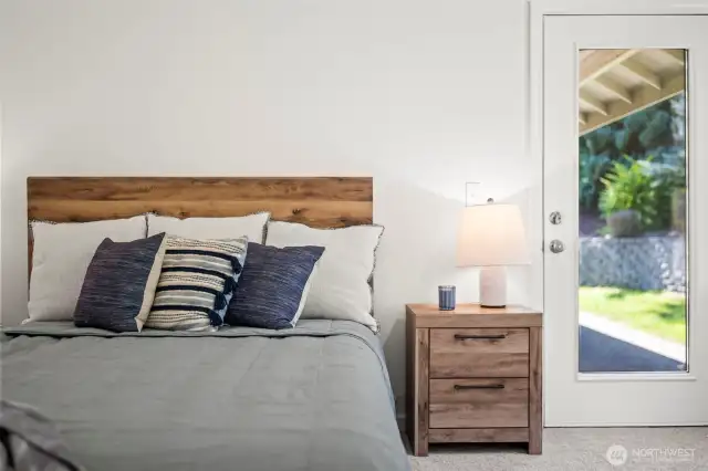Primary bedroom with raised ceilings and access to the private back patio.