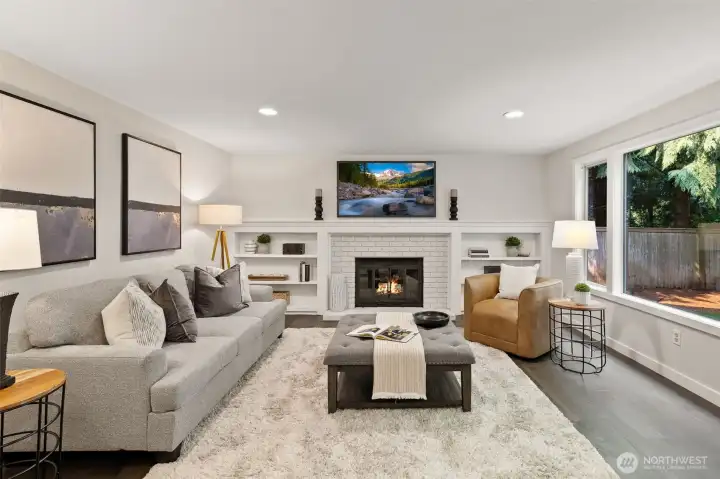 Family room with wood burning fireplace.