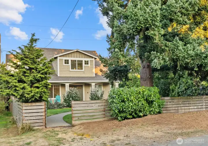 House from street. Private behind fence.