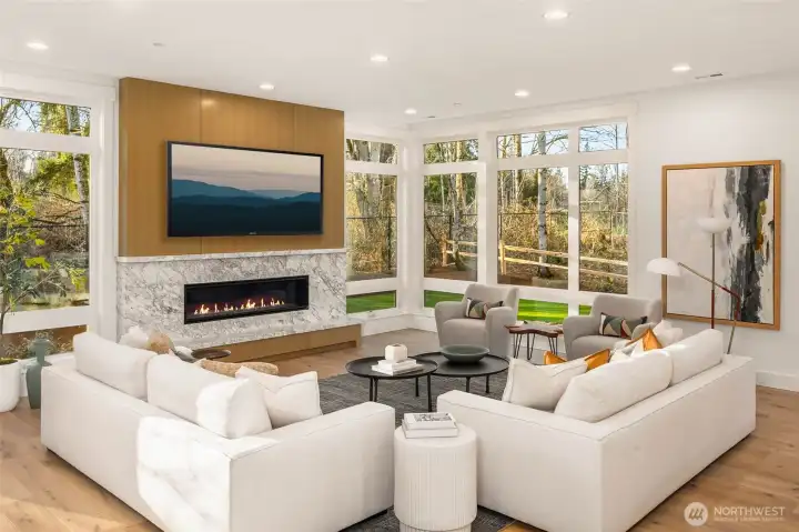 Great room flooded with natural light through floor to ceiling molding encased windows and 10 foot ceilings