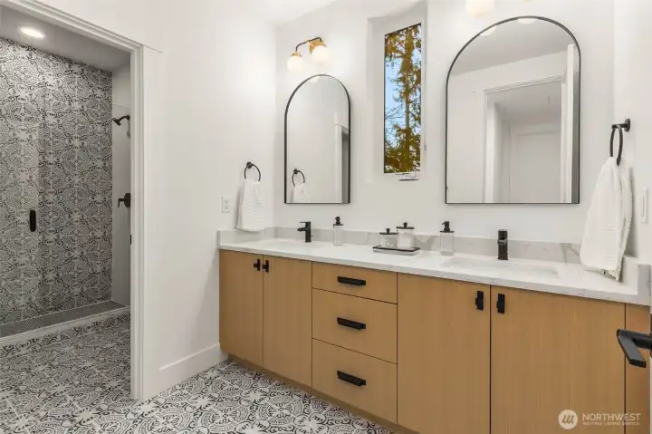 One of 2 secondary second floor bathrooms featuring designer selected tile and mud set tile shower with frameless glass door