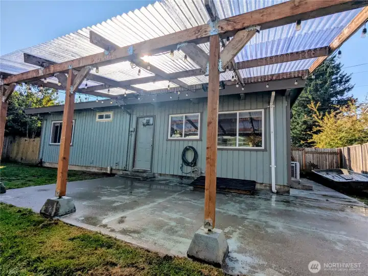 Side yard has paved walkway to gate to front yard