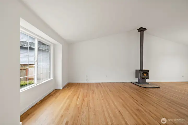 Enter into the spacious living room w/wood burning stove