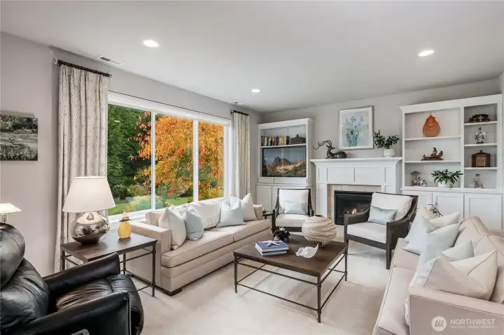 Family room with custom built bookshelves and mantle over the gas fireplace.