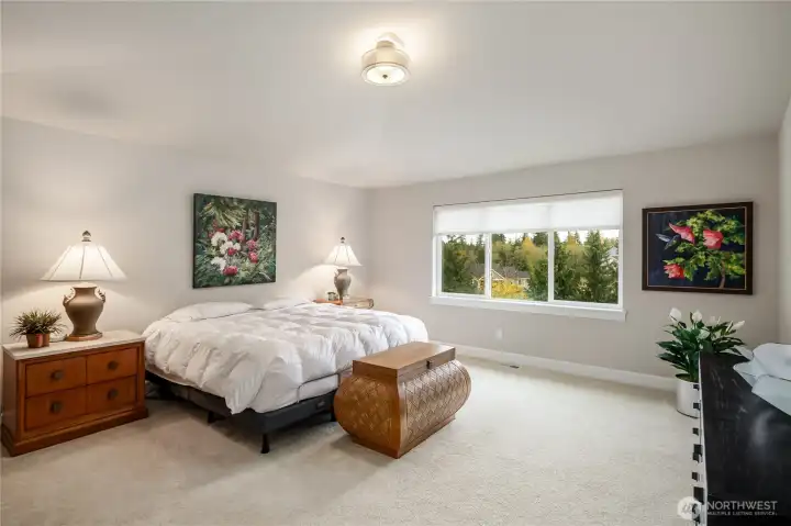 Double doors lead you into the spacious primary bedroom.