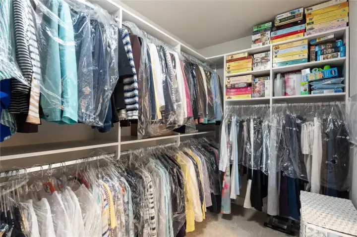 Large walk-in closet with custom shelving and organizers.