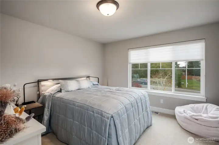 The second bedroom has white millwork, custom paint and is very light.