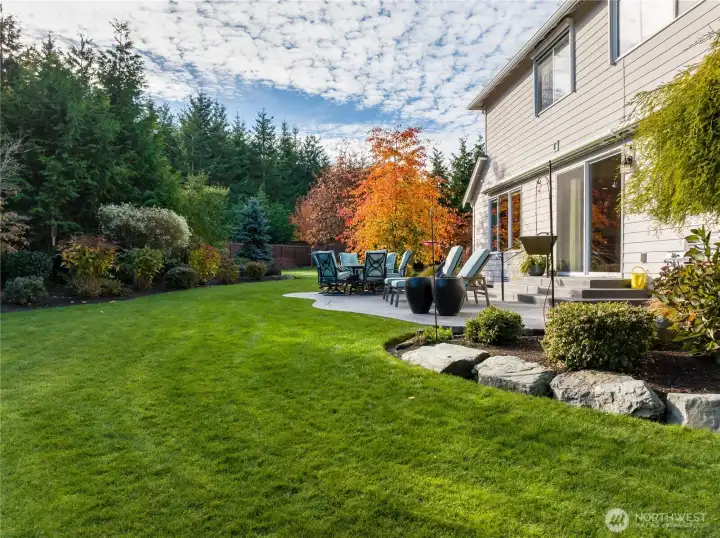 Oversized patio with automatic awning, mature landscaping that has been professionally done.