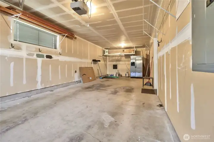 A two-car tandem garage offers a door to the main level hallway. A 3rd parking space is located in front of the garage.