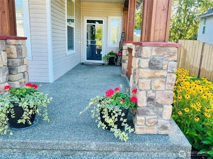 Warm stone accents and welcoming entry details create an elegant first impression before you even step inside.