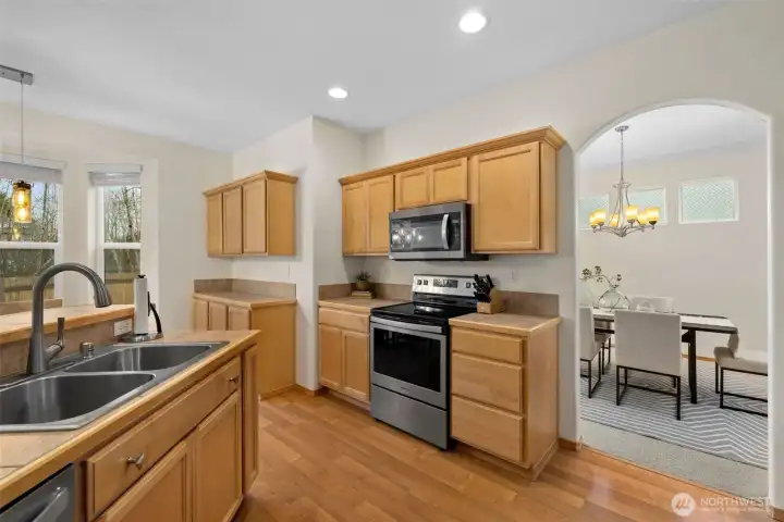 A bright and functional kitchen with seamless flow to gathering spaces—perfect for entertaining while staying connected.