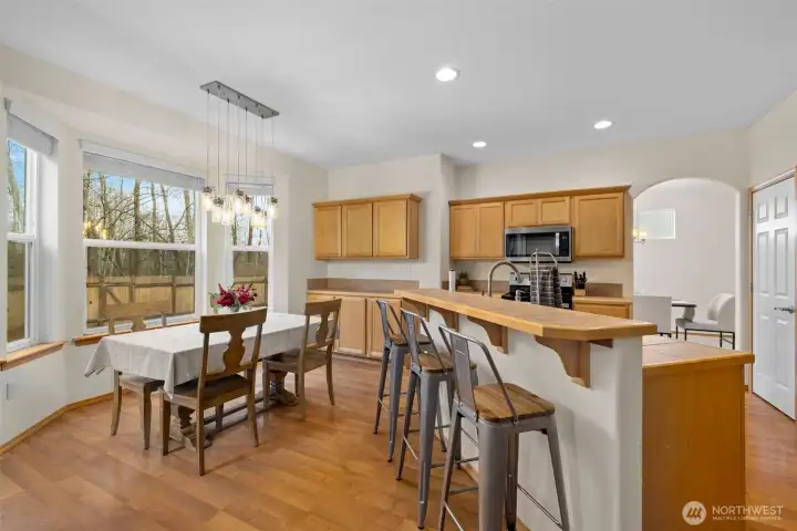 A sunny breakfast nook wrapped in windows offers tranquil greenbelt views while you dine.