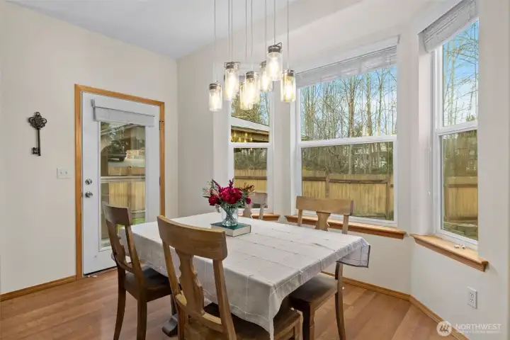 Walls of windows frame peaceful natural surroundings, creating a serene backdrop for everyday meals and special occasions alike.