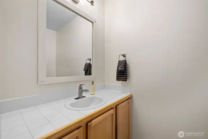 A thoughtfully placed main-level powder room adds convenience for guests and daily living.