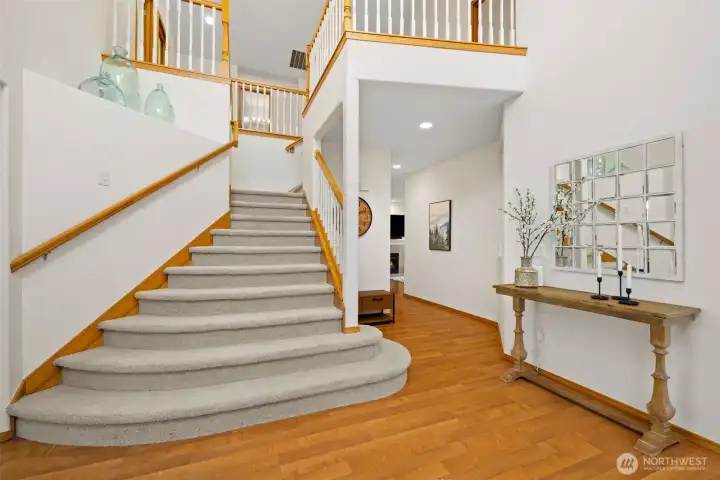 An elegant staircase with open railing detail enhances the home’s architectural presence and airy design.