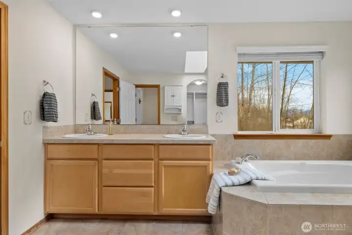 Ample counter space and storage ensure functionality meets comfort in this thoughtfully designed primary suite.