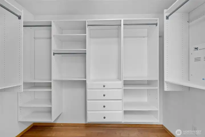 A generous walk-in closet with built-in organization makes wardrobe storage effortless and refined.