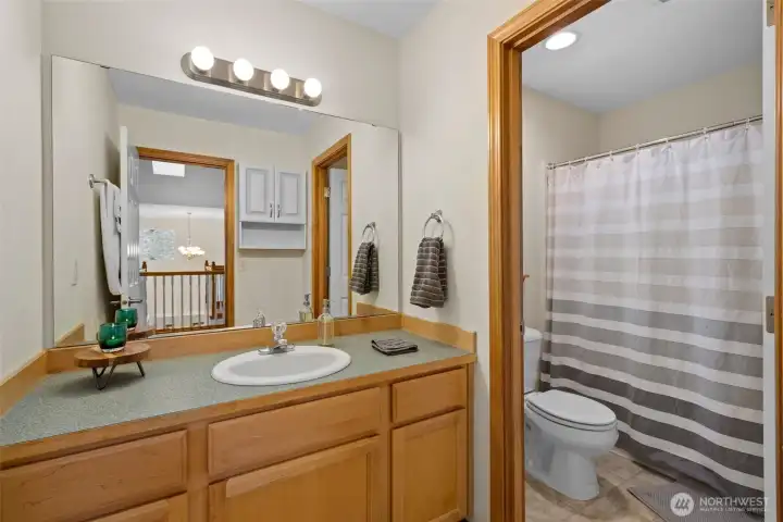 Bright and functional with clean finishes and ample storage, this full bath comfortably serves the upper-level bedrooms.