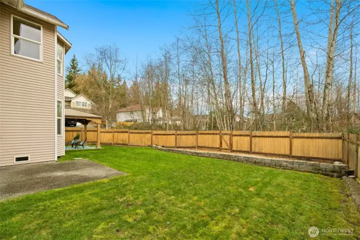 Fully fenced and expansive, the backyard opens to tranquil greenery, offering rare privacy and room to play, garden, or simply relax.