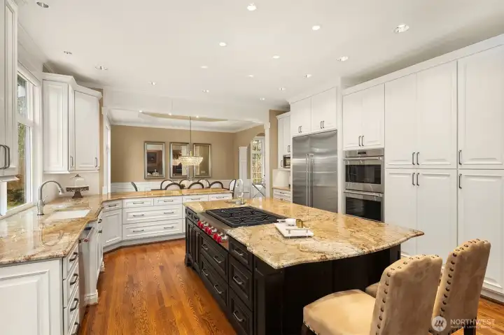Gorgeous, spotless, expanded and remodeled Chef's kitchen ~ granite counters, huge island, eating bar, 6-burner Wolfe range, double ovens, SubZero fridge and abundant cabinet & counter space.