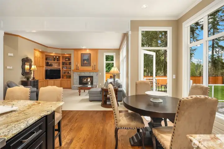 A large, adjacent breakfast nook that overlooks the South-facing back yard.  Floor-to-ceiling windows provide natural light throughout the main level.