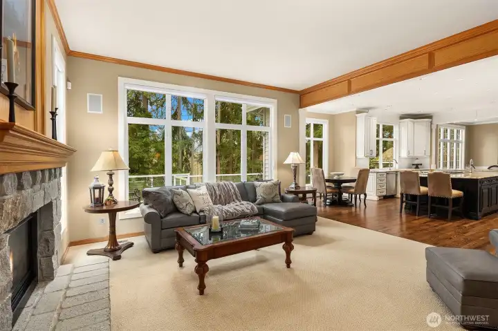 Family room with stone fireplace and built-in shelving. Private, wooded outlooks from nearly every room in the home.