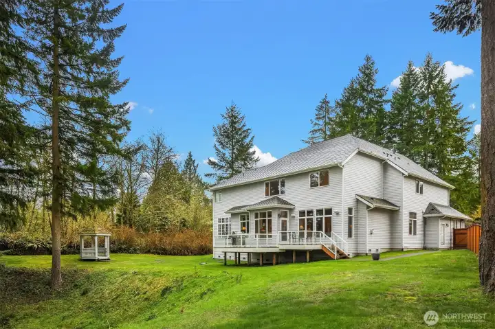 The back yard offers the home with its own outdoor/yard space, and the native growth provides a privacy buffer to the community park.