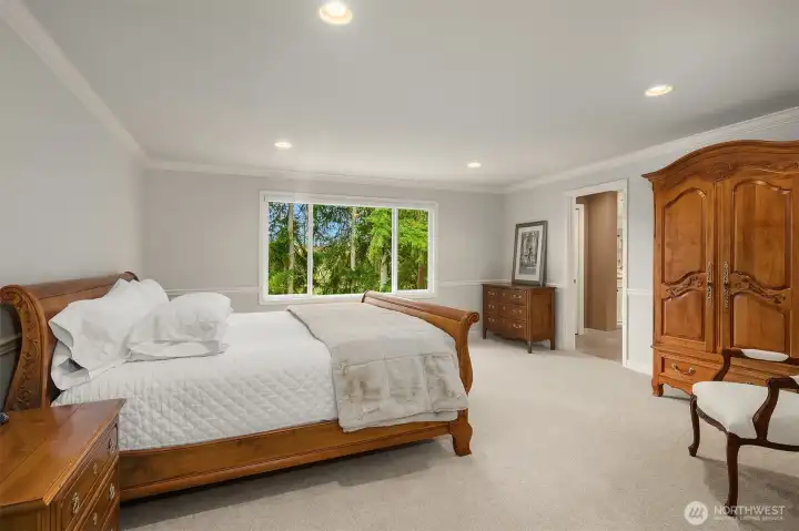 Spacious primary suite ~ serene views of the greenbelt. Large, lavish, spa-inspired en-suite bath with frame-less glass door dual head shower, heated Travertine tile floors, soaking tub, and large walk-in closet.