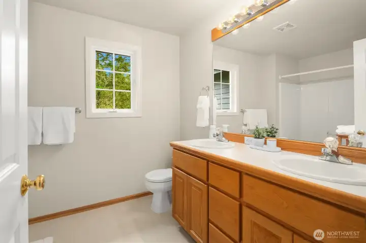 The upper-level full main bath serves the other secondary bedrooms.
