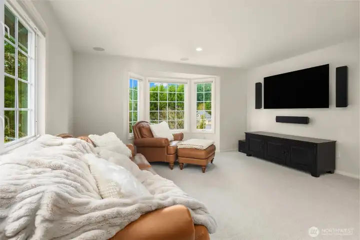 A spacious upper-level bonus room is complete with built-in surround-sound speakers, and provides more private outlooks to the back yard.