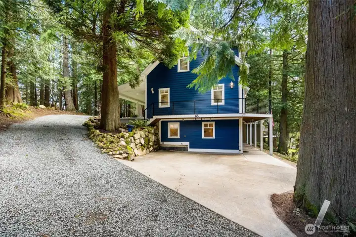 Large driveway with an additional parking spot to the left.