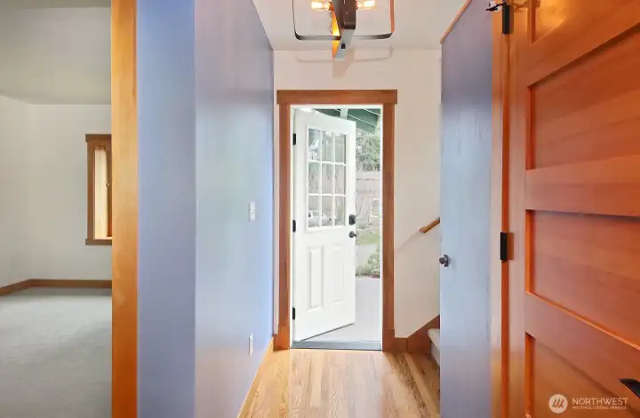 Looking back toward the front door, the primary bedroom is on the left and a spacious closet on the right for coats and miscellaneous items...seller used the space for a wine rack.