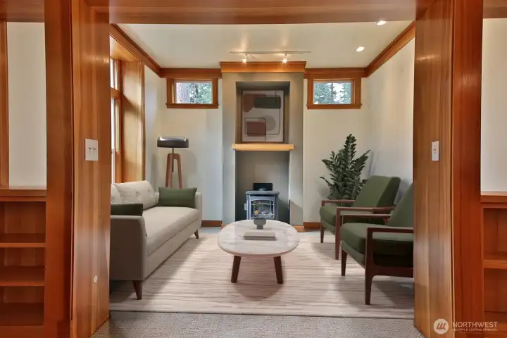 Living room with a propane freestanding stove.  Virtually Staged.