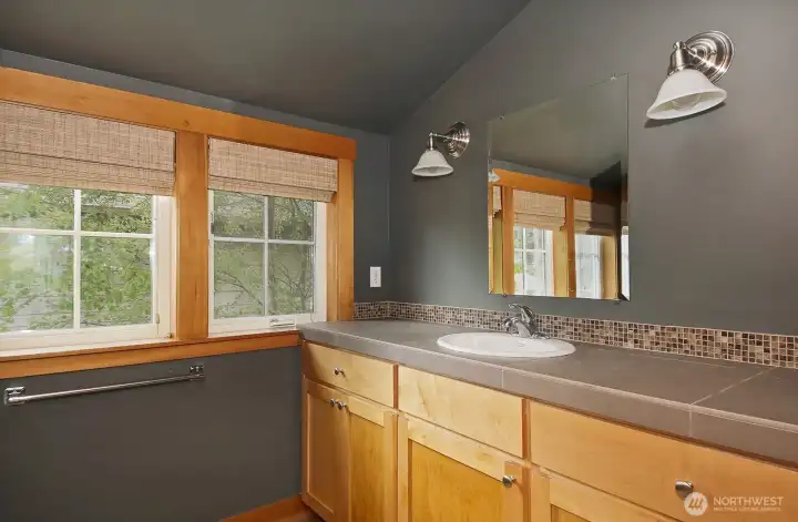 The cabinetry throughout the house is maple.  The baths have tile countertops.
