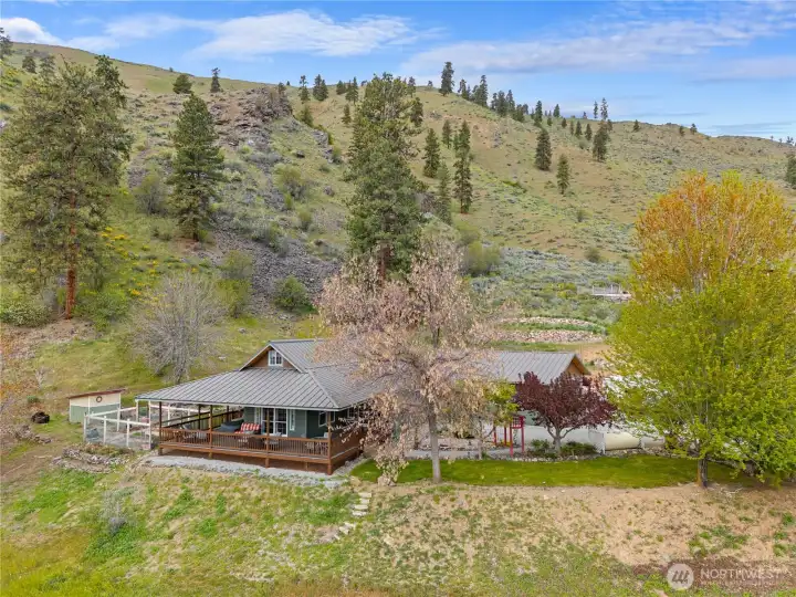 Set against the hillside, the home enjoys a peaceful, private setting with mature trees and natural surroundings