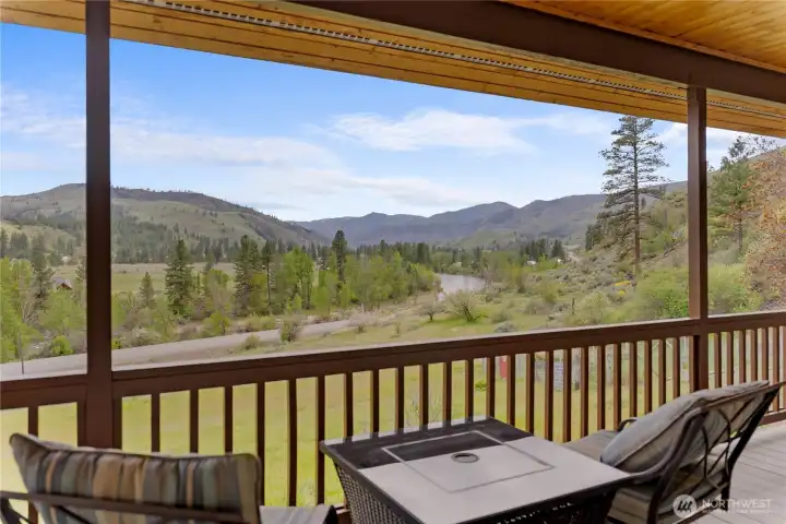 Covered deck with expansive views of the river, valley, and surrounding mountains, perfect for relaxing or entertaining