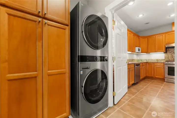 Garage side entry and utility area with laminate flooring, storage, and laundry, offering everyday convenience and easy access to the kitchen. New HVAC Furnace & AC, new hot water tank too