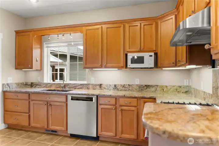 Spacious kitchen with ample prep space, and an inviting eating bar—perfect for gathering, cooking, and keeping the cook company.  Propane kitchen range.