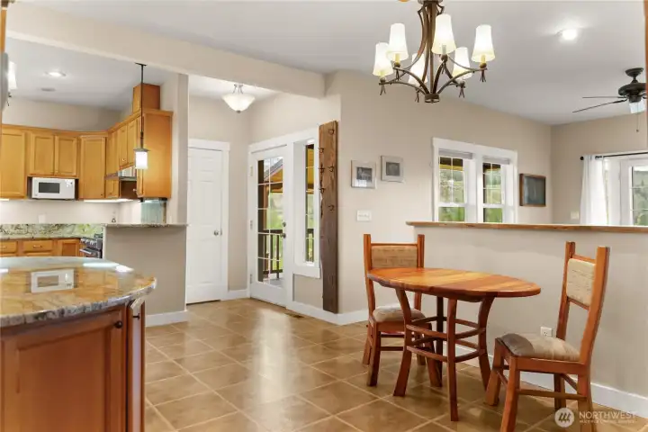 Open kitchen and dining area with warm wood cabinetry, generous counter space, and an easy, functional layout
