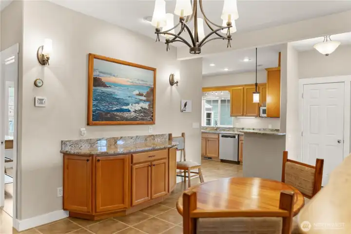Dining area with built-in cabinetry and granite counter, conveniently connected to the kitchen for easy entertaining