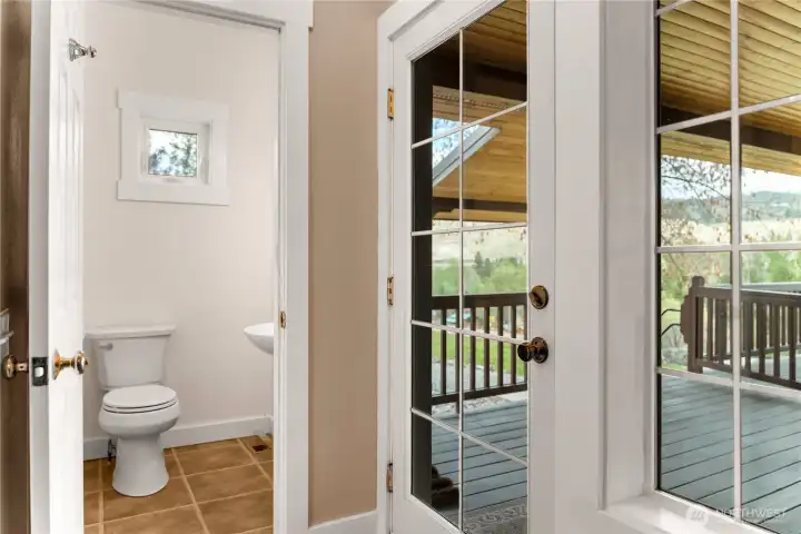 Glass door opening to the covered deck, main floor powder room conveniently located for guests and everyday usecreating an easy indoor-outdoor connection and