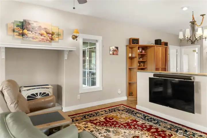Custom blue pine shelf above the TV adds warmth and a unique, handcrafted touch to the living space