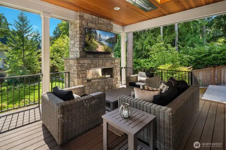 Covered outdoor living area with flush-mount overhead heaters.